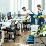 Professional commercial cleaning services team in Gibraltar sanitizing a modern corporate boardroom.