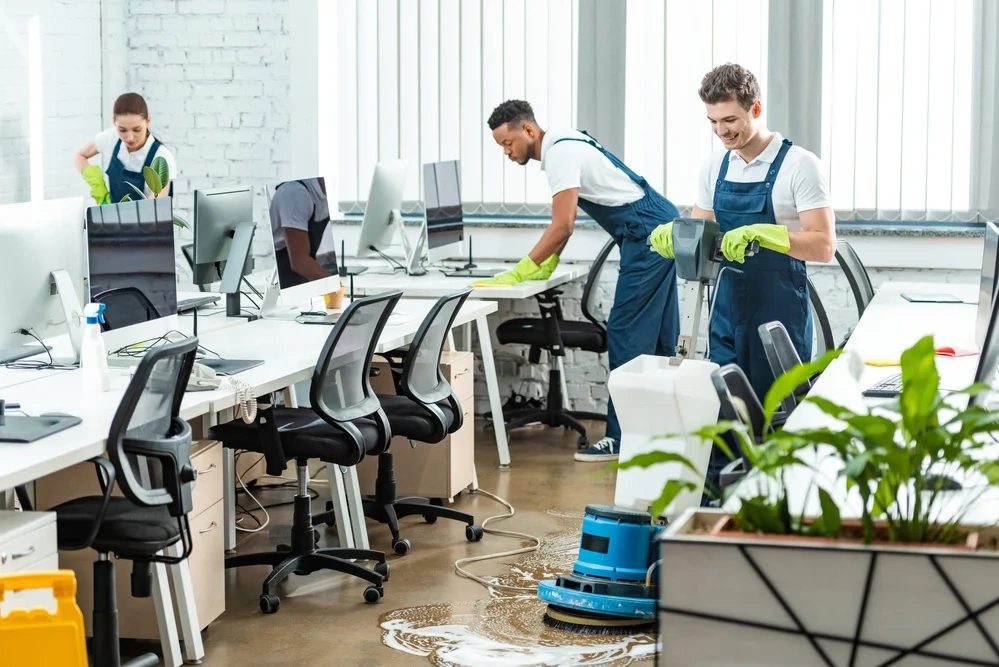 Professional commercial cleaning services team in Gibraltar sanitizing a modern corporate boardroom.