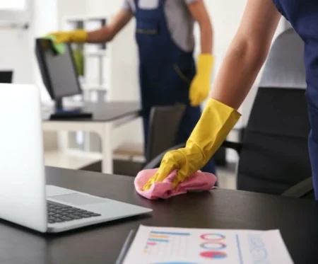 Cleaning RHS commercial staff vacuuming a modern open-plan office in Gibraltar World Trade Center.