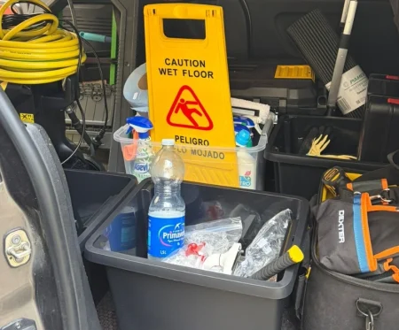 Cleaning RHS professional sanitising kitchen countertops and appliances in a Gibraltar apartment.