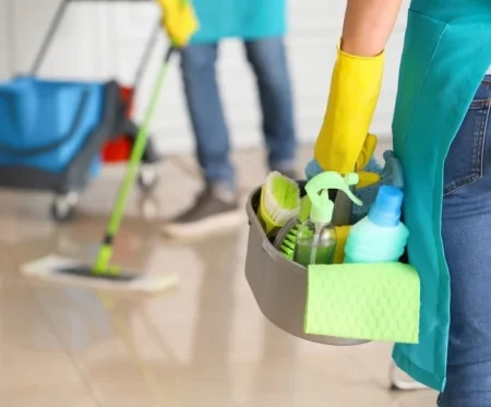 Premium residential cleaning service in Gibraltar dusting a luxury living room.